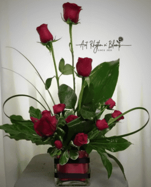 Elegant bouquet of red roses with green leaves.