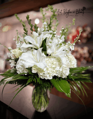 Elegant white floral bouquet with lilies and hydrangeas.