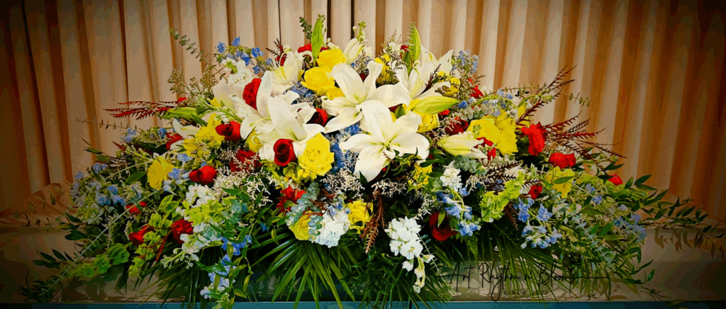 A vibrant floral arrangement with lilies, roses, and assorted flowers.