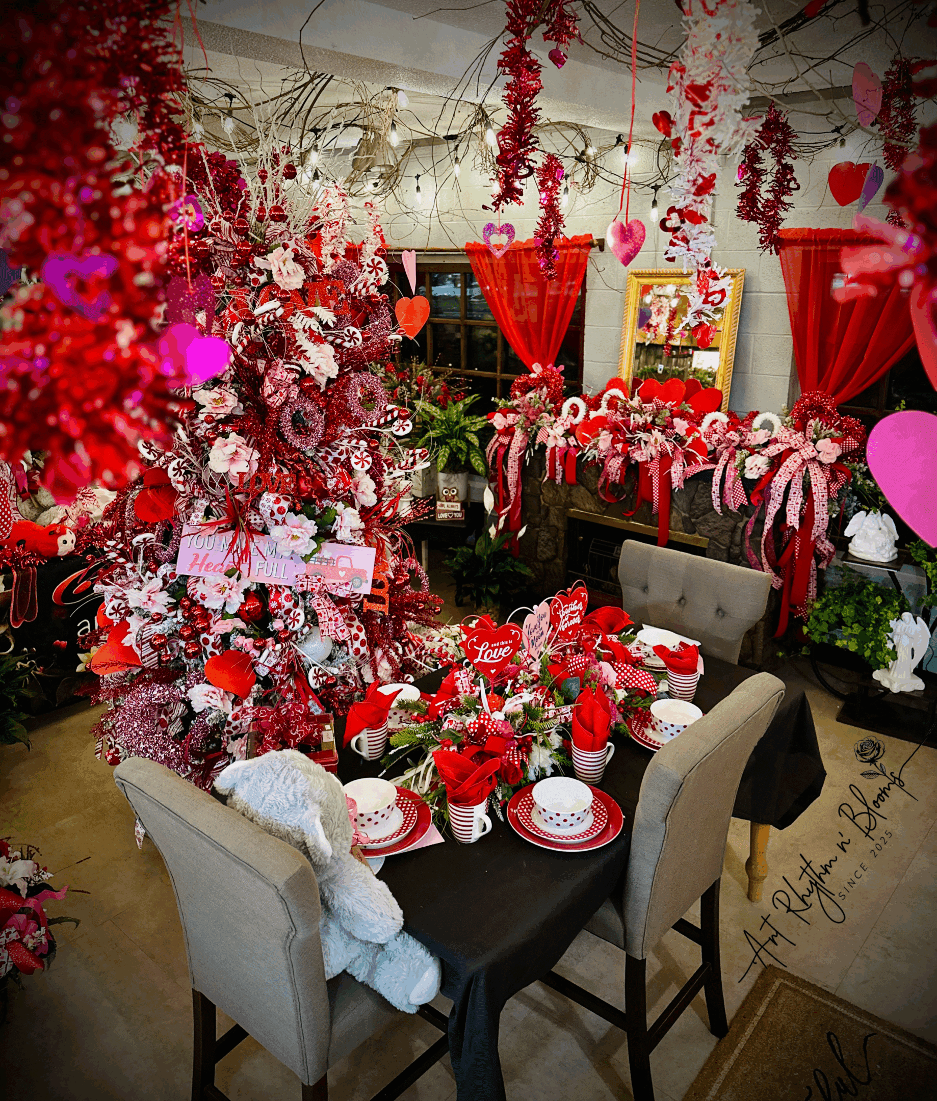 A romantic, red-themed dinner setup with lavish floral decorations.